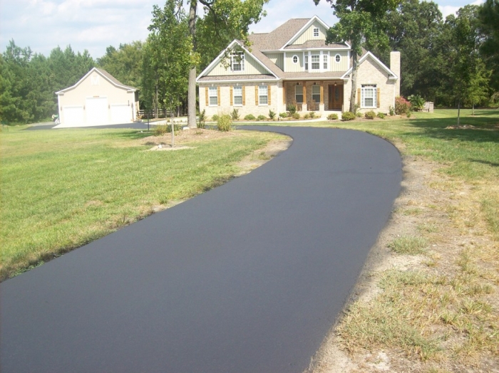 seal coated asphalt driveway in front of home